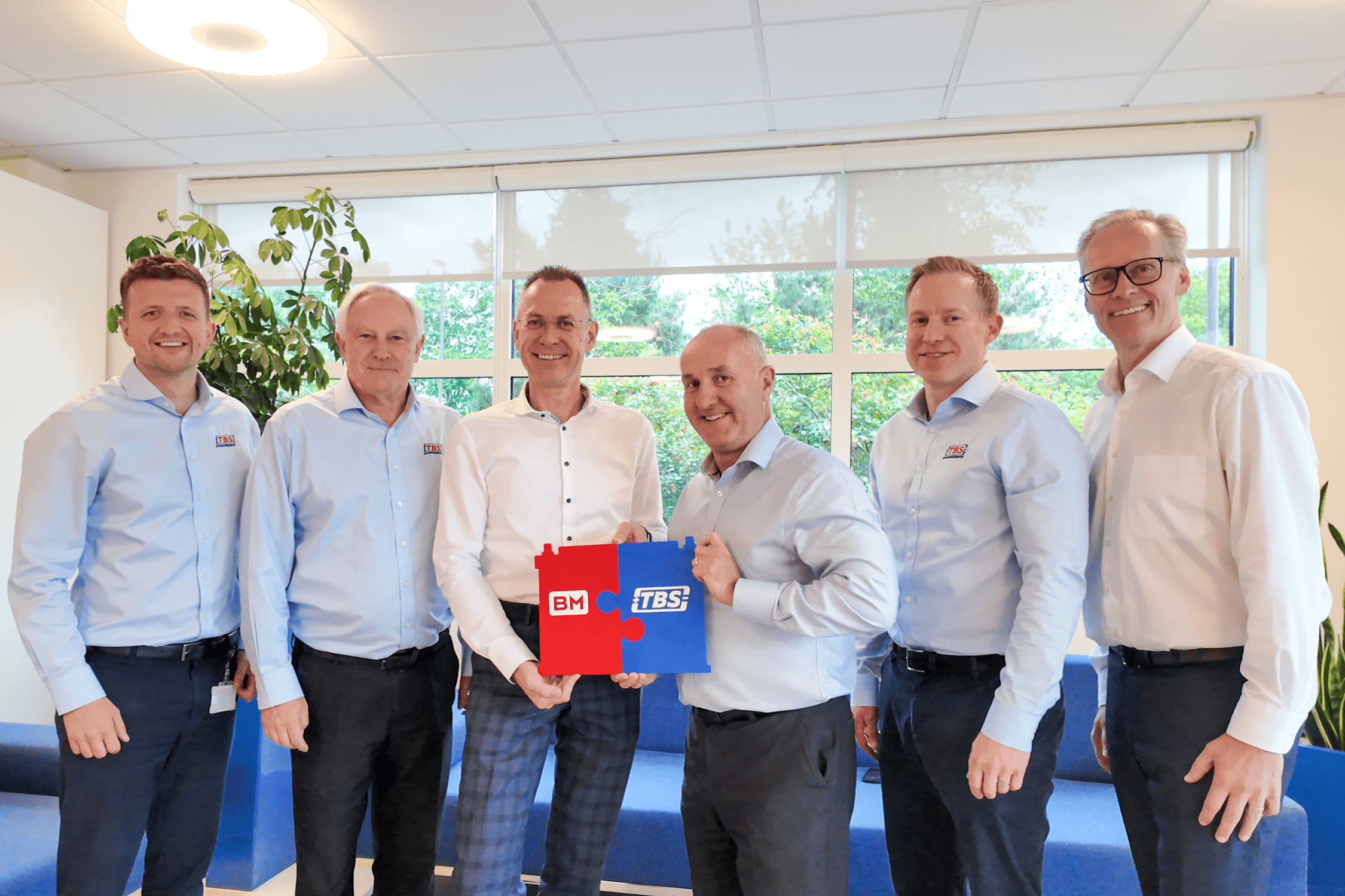 Innovative team at Rosendahl Nextrom celebrating a successful partnership, showcasing collaboration and industry leadership in cable and fiber optic manufacturing solutions.